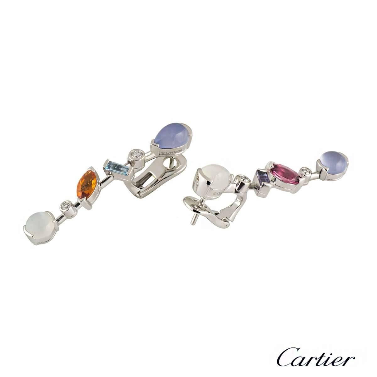 A beautiful pair of earrings in platinum from the Cartier Meli Melo collection. The earrings consist of varying cuts of diamonds, aquamarine, chalcedony, garnet, iolite, pink tourmaline and moonstone set onto a knife edge horizontal bar. The