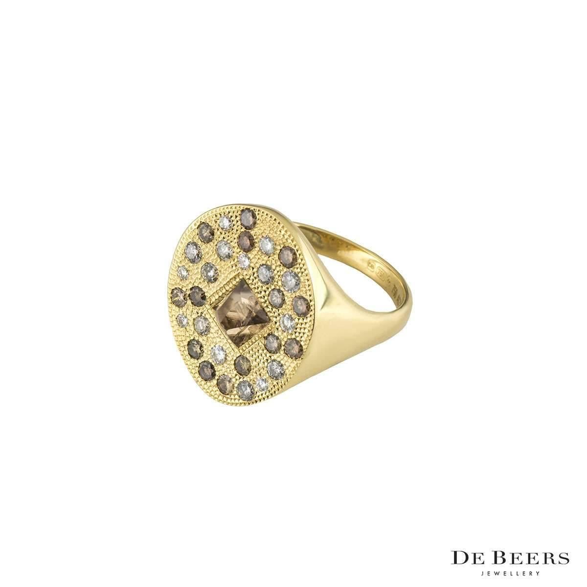 A unique 18k yellow gold De Beers diamond ring from the Talisman collection. The ring comprises of 31 rough diamonds which come to an approximate weight of 1.37ct, in various colours. The ring is a signet style which tapers to 2mm. The ring has a