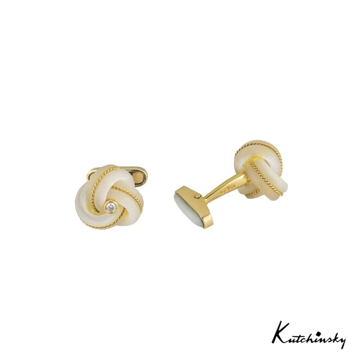 A unique pair of 18k yellow gold, mother of pearl and diamond cufflinks from Kutchinsky. The cufflinks feature a mother of pearl knot style with yellow gold beading running in the middle of each wrapped piece. The mother of pearl knot meets with a