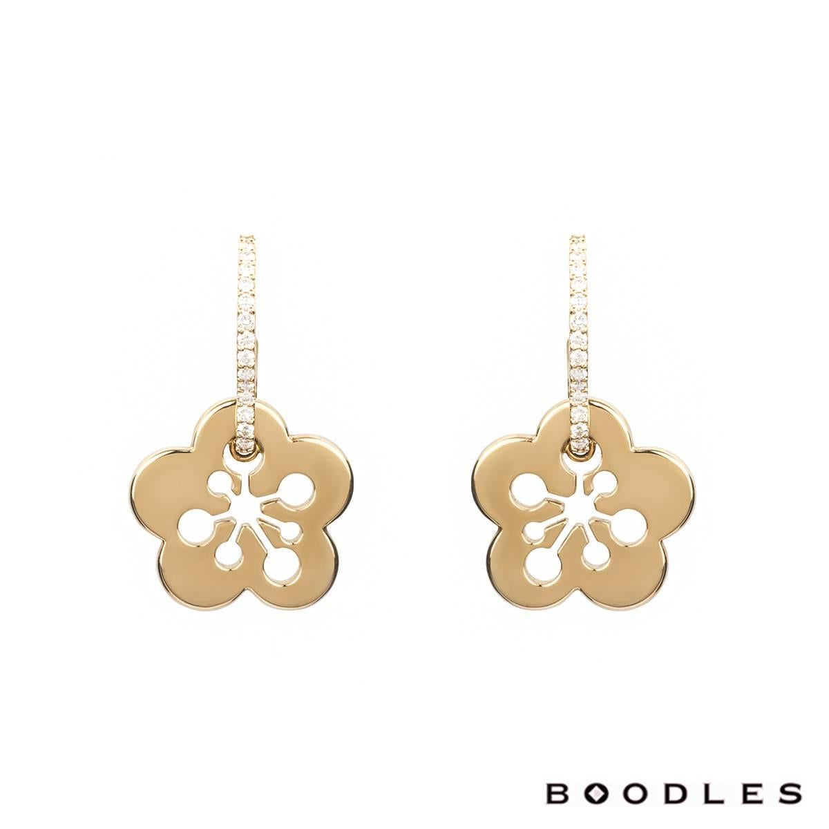 A stunning pair of 18k rose gold diamond set earrings from the Blossom collection by Boodles. The earrings are set in an open work half floral design, which is pave set with round brilliant cut diamonds totalling 0.25ct and suspended from this is a