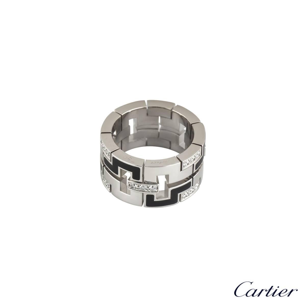 An 18k white gold dress ring from the Le Baiser Du Dragon collection by Cartier. The square abstract design alternates with polished, black enamel and diamond set links. The ring has 27 round brilliant cut diamonds with a total carat weight of