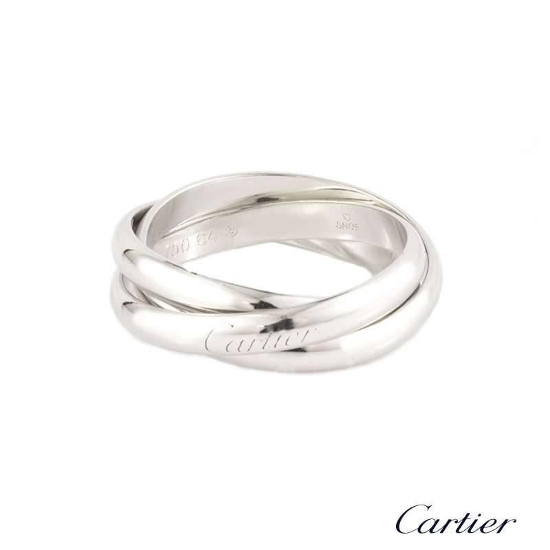 An 18k white gold gent's ring from the Trinity de Cartier collection by Cartier. The ring comprises of three interlocking 4mm bands, one of which is inscribed with the iconic Cartier logo along the outer edge. The ring is a US 10 3/4, EU size 63 3/8