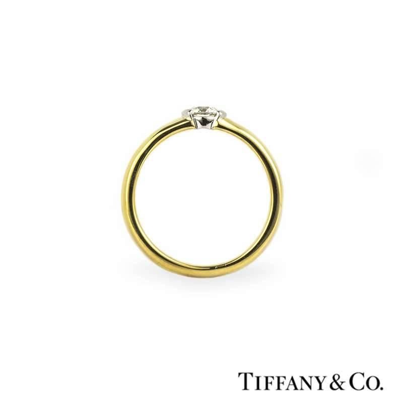 An 18k yellow gold single stone diamond ring from the Tiffany & Co. Etoile collection. The bezel set round brilliant cut diamond weighs 0.33ct, the colour is G and the clarity is VS1. The ring is a US size size 6, EU 52 3/4 and UK size M but can
