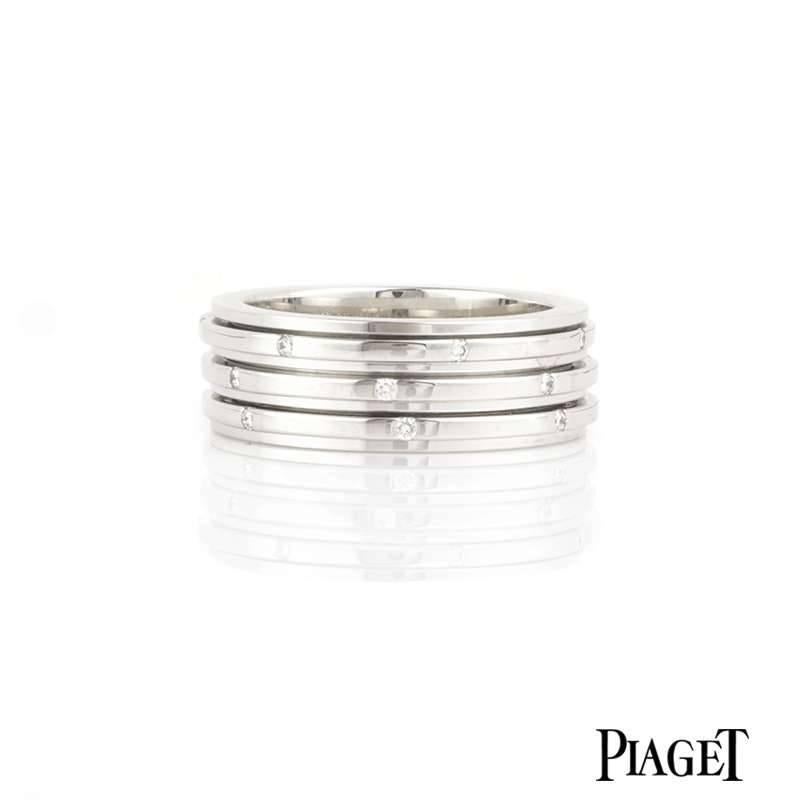 A Piaget Possession ring in 18k white gold, set with 21 round brilliant cut diamonds. Seven diamonds are set around the outer edge of each of the 3 bands, which move freely in perpetual movement. The band width is approximately 7.00mm and has a