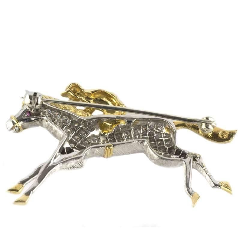 A beautiful horseracing diamond set brooch in platinum and 18k yellow gold. The brooch consists of a horse motif, set with approximately 0.57ct round brilliant cut diamonds predominantly set in platinum with 18k yellow gold detailing on the tail,