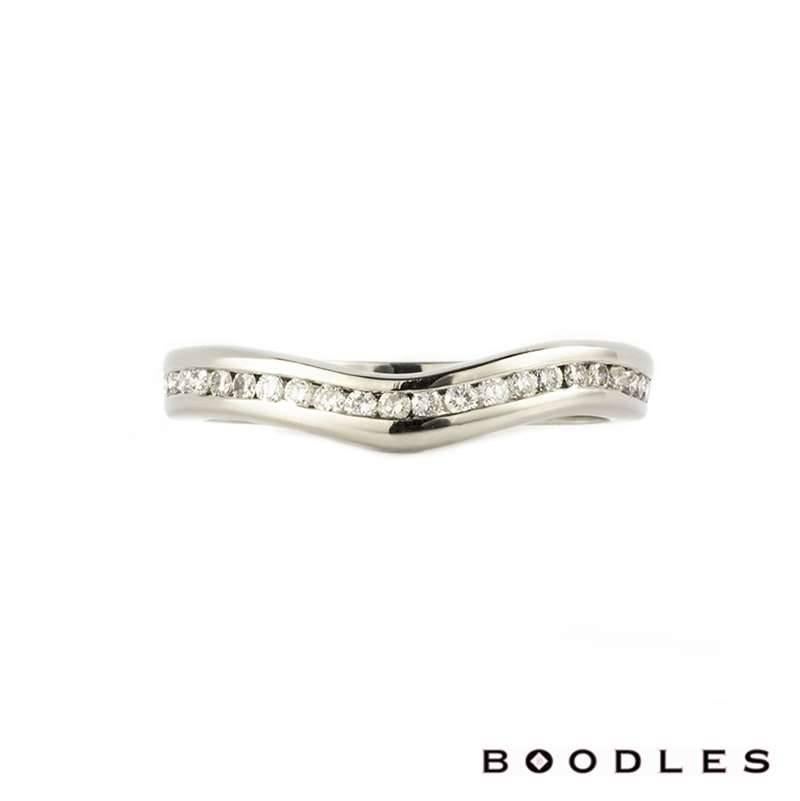 A Boodles platinum shaped diamond wedding band. The ring is comprised of 25 round brilliant cut diamonds totalling approximately 0.50ct, colour G and VS clarity, set within a shaped channel setting. The 3mm ring is currently a US size 5 3/8, EU