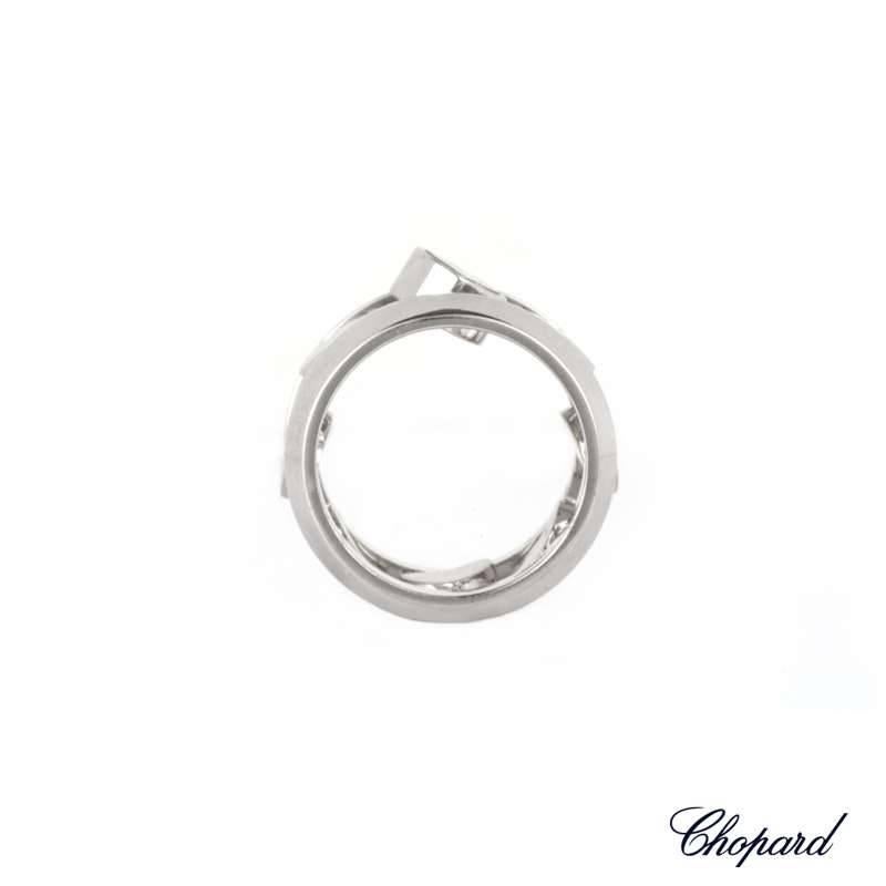 An 18k white gold Chopard Happy Amore ring. The ring is comprised of two teminations which are joined in the middle by eight mobile heart links. Seven of the links are solid hearts whilst one has the signature Chopard floating diamond totalling