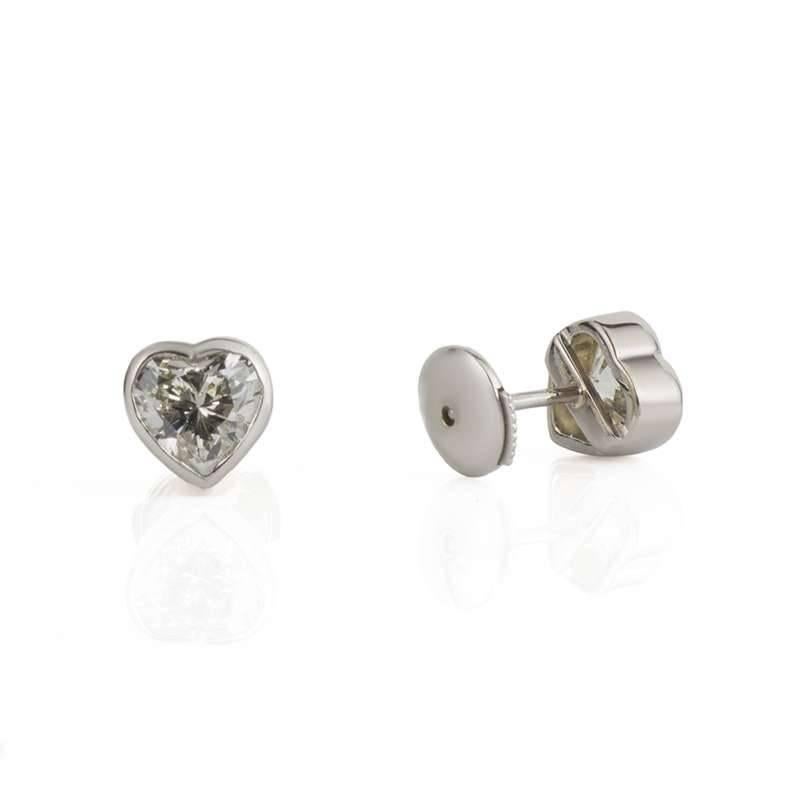 A Pair of 18k White Gold Heart Cut Diamond Earrings Totalling 2.20ct, One Diamond Weighing 1.09cts G Colour, VS1 Clarity, the Other Weighing 1.11cts, F Colour, VS2 Clarity. The Diamonds are set in a Rubover Style Setting.

Complete with Rich