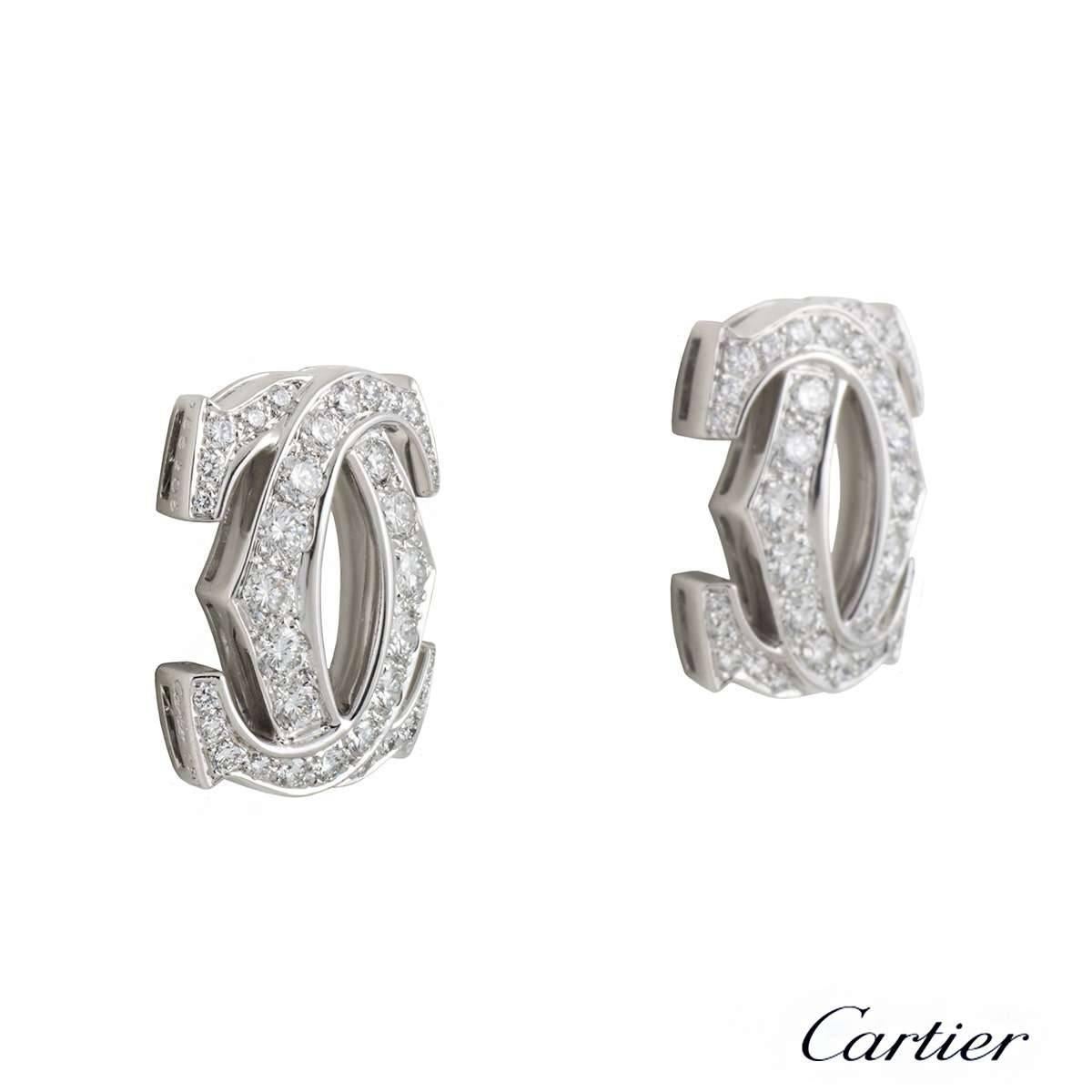 A pair of 18k white gold Cartier earrings from the C de Cartier collection. Each earring is composed of the iconic C de Cartier, interweaving C motifs with 34 graduated round brilliant cut diamonds with a total of approximately 2.02ct, G colour and