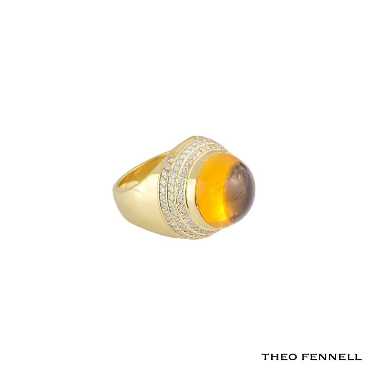 A fashionable 18k yellow gold dress ring by Theo Fennell. The dome shaped ring is set to the centre with a cabochon cut orange amethyst weighing approximately 12.00ct complimented by three circular rows of round brilliant cut diamonds totalling