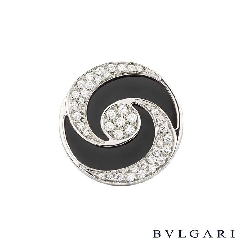 An 18k white gold and stainless steel onyx and diamond spinning ring from the Optical Illusion collection by Bvlgari. The ring is set to the centre with a rotating disc design which is pave set with round brilliant cut diamonds totalling