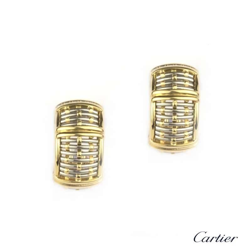 A pair of Cartier diamond set hoop earrings in 18k yellow and white gold. Each earring is composed of a series of hoops interwoven with supporting bands to a wider outer band and has 12 round brilliant cut diamonds set in a row of two. The width of