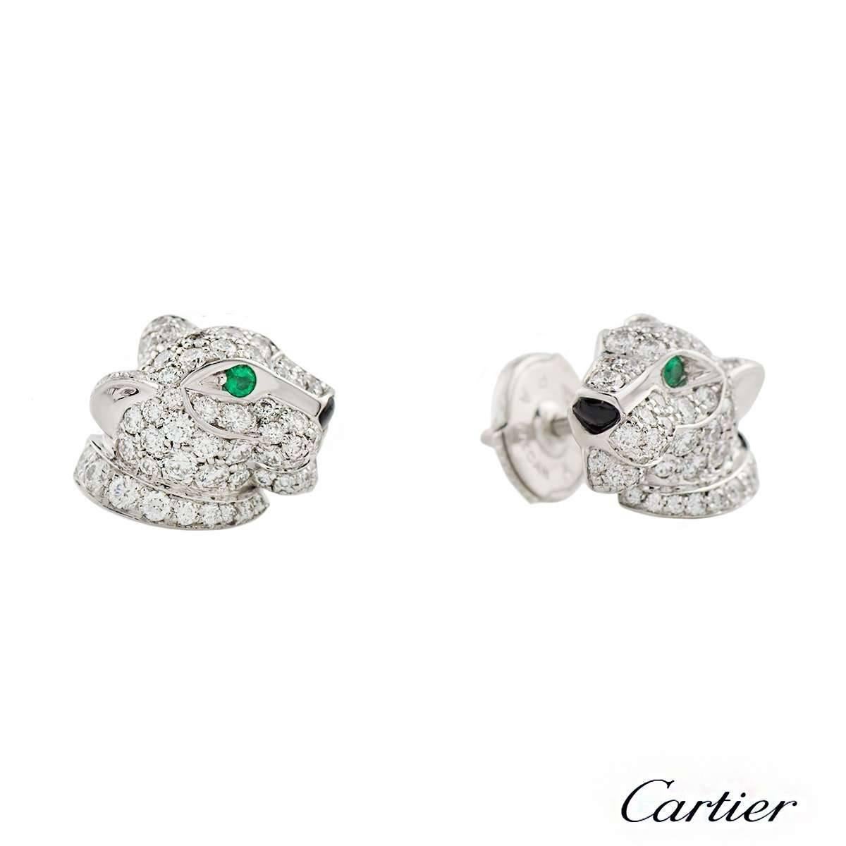 A delightful pair of Cartier 18k gold diamond, emerald and onyx earrings from the Panthere de Cartier collection. The earrings comprise of the panthere motif encrusted with 63 round brilliant cut diamonds in each with an onyx for the nose and