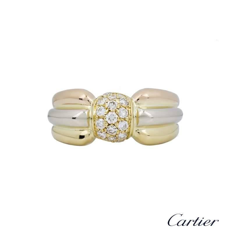 A stunning 18k three colour gold diamond set ring from the Cartier Trinity collection. The ring is set with a raised bombe centre, pave set with 16 round brilliant cut diamonds totalling approximately 0.20ct. The central design is accentuated by 18k