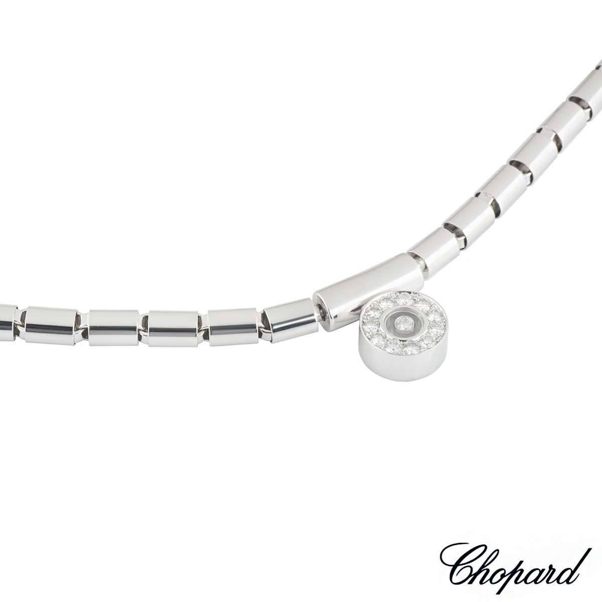 An 18k white gold necklace from the Happy Diamonds collection by Chopard. The necklace features a circular 1.3cm motif to the centre, set with 11 round brilliant cut diamonds around the outer edge. In the centre of the motif is a single floating