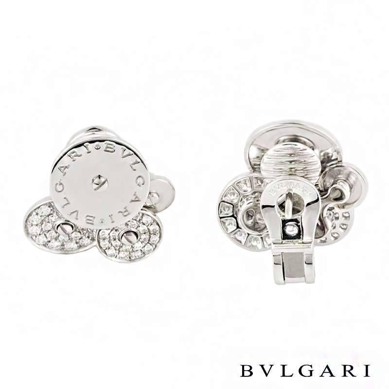 A pair of 18k white gold earrings from the Bvlgari Cicladi collection. Each earring is composed of a cluster of 4 spinning circular discs, each graduating in size. The largest disc is engraved with the Bvlgari Bvlgari logo with a further two discs