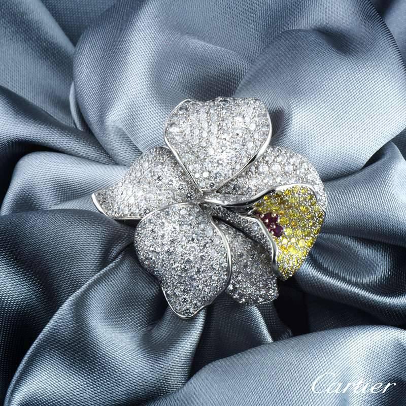 A luxurious and rare platinum Cartier ring from the Caresse D' Orchidees collection, matching the Caresse D'Orchidess earrings. The ring comprises of a Orchid motif with 5 petals embellished with round brilliant cut diamonds. The lip of the orchid