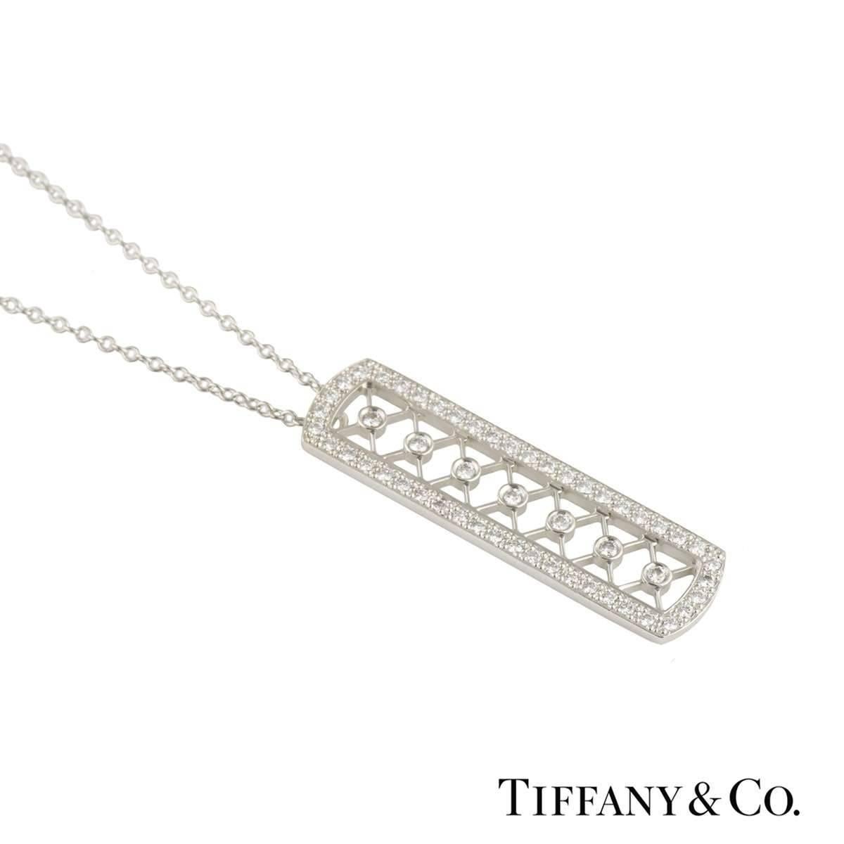 A stunning platinum Tiffany & Co. diamond pendant. The pendant comprises of a rectangular open work motif with 46 round brilliant cut diamonds around the outer edge in a pave setting. Complimenting the outer edge is a criss cross open work