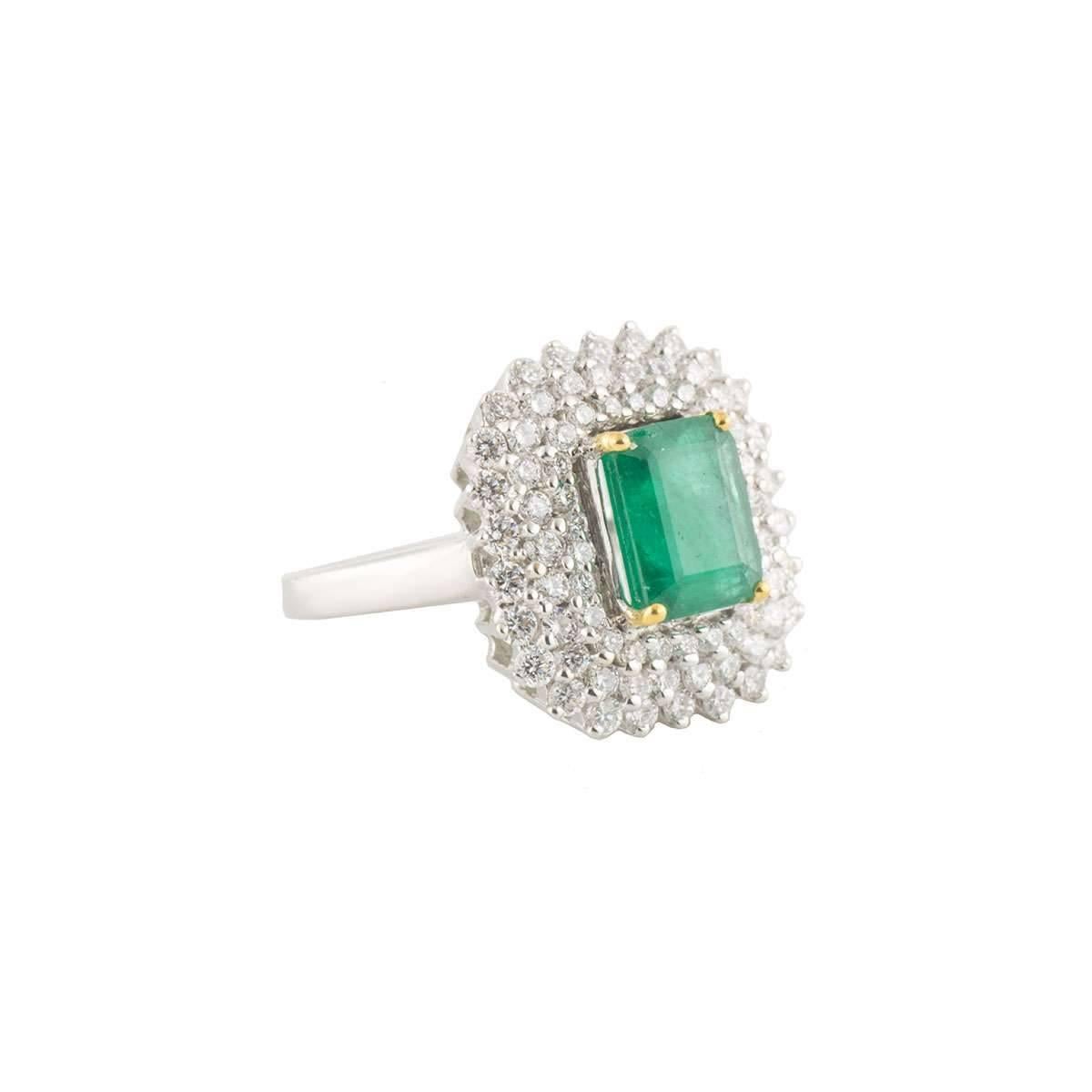 A beautiful 18k white gold diamond and emerald dress ring. The ring comprises of a emerald cut emerald with a weight of 2.49ct with a deep green throughout. Complimenting the emerald are 78 round brilliant cut diamonds set over 3 graduated with 3