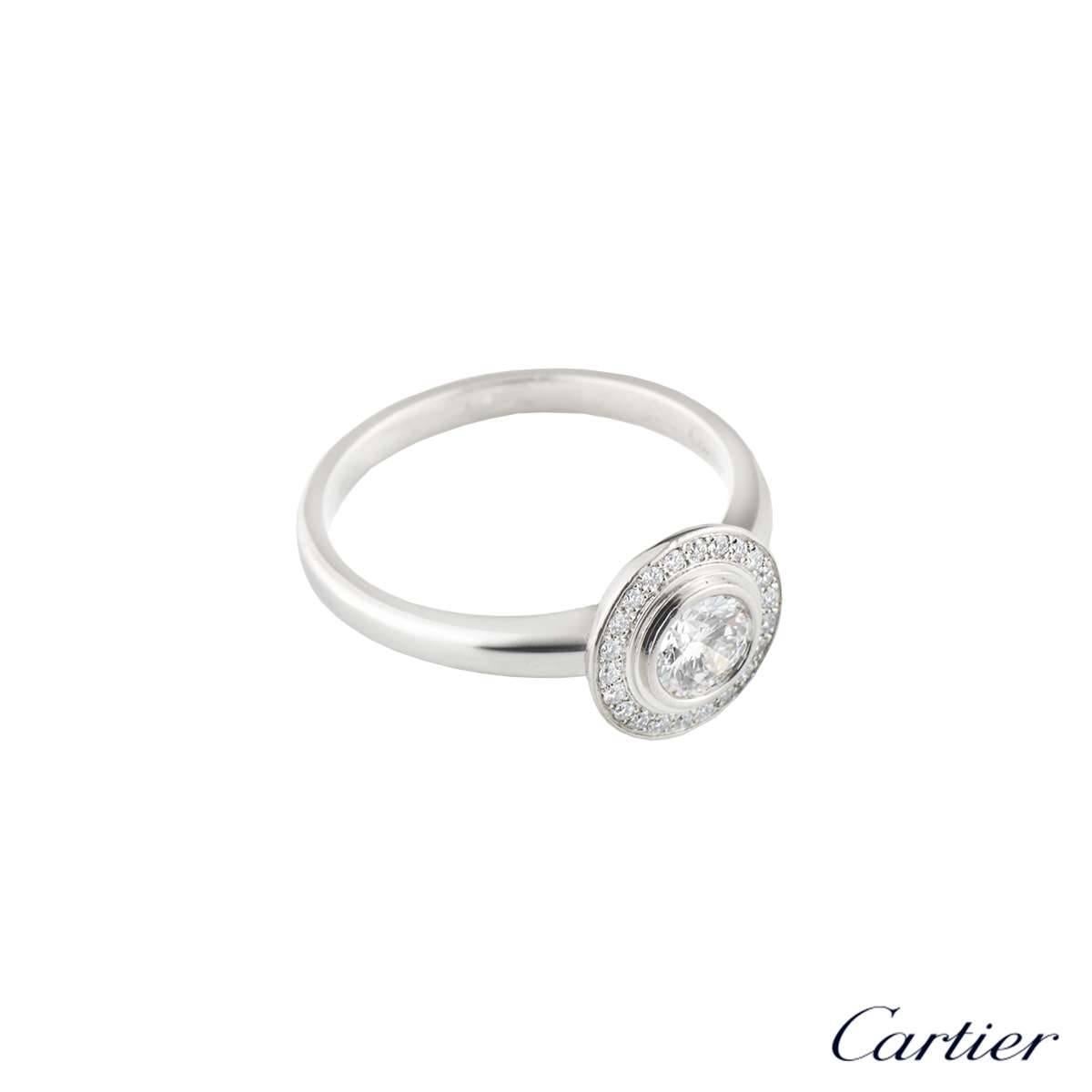 A luxurious platinum Cartier diamond engagement ring from the Cartier D'Amour collection. The ring comprises of a round brilliant cut diamond in a rubover setting with a total weight of 0.37ct, predominantly D colour and VVS1 clarity. Complimenting