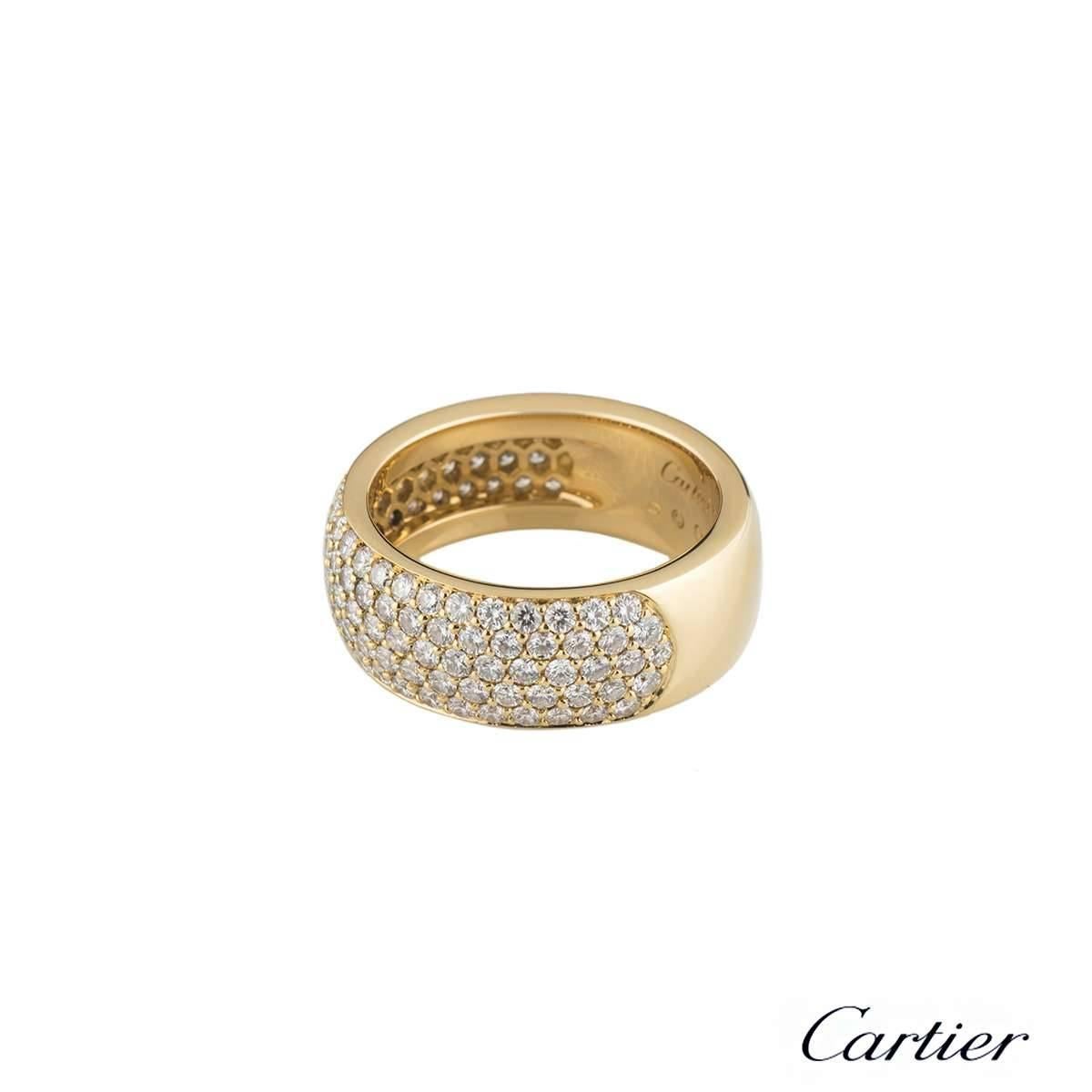 A stunning 18k yellow gold diamond dress ring by Cartier. The ring is set to the front with approximately 118 round brilliant cut pave set diamonds, totalling approximately 2.36ct. The diamonds are predominantly F colour and VS in clarity. The 8mm