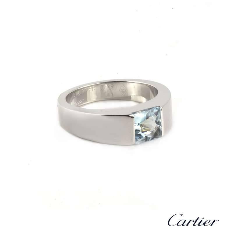 A Cartier 18k white gold Tank ring. The ring comprises of a centre set princess square cut aquamarine with a buff top, measuring 5.5mm with a total weight of approximately 0.62ct. The ring is a US size 5 2/3, EU size 51 and UK size L. The total