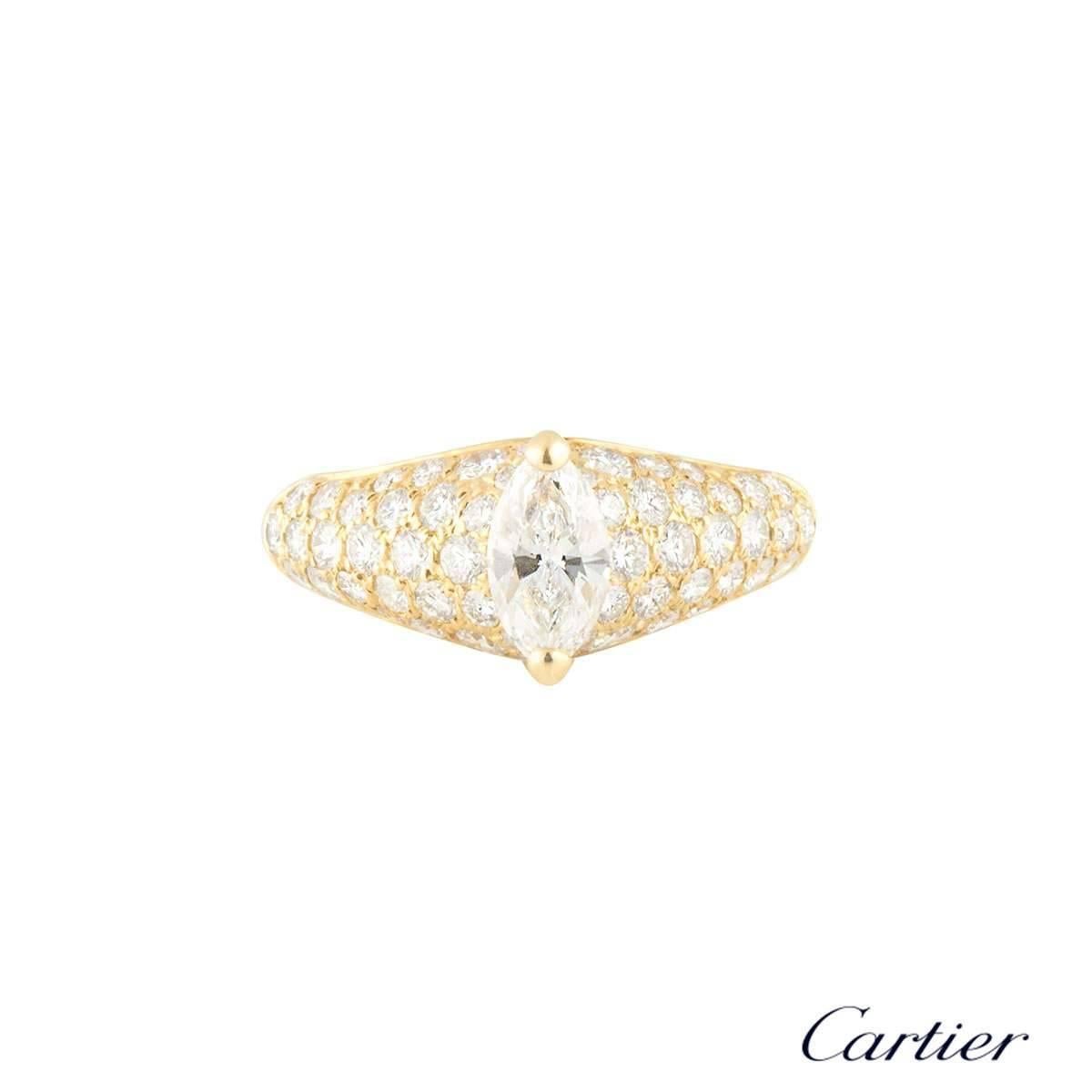 A sparkly 18k yellow gold Cartier diamond engagement ring. The ring comprises of a marquise cut diamond in a 2 claw settings with a total weight of approximately 0.75ct, G colour and VVS2. The diamond is complimented with 54 round brilliant cut