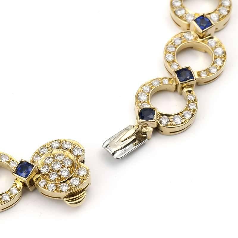 A sapphire and diamond bracelet in 18k yellow gold. The bracelet is composed of 16 open work circular links, each pave set with round brilliant cut diamonds totalling approximately 3.00ct, colour G and VS clarity, complemented by princess cut