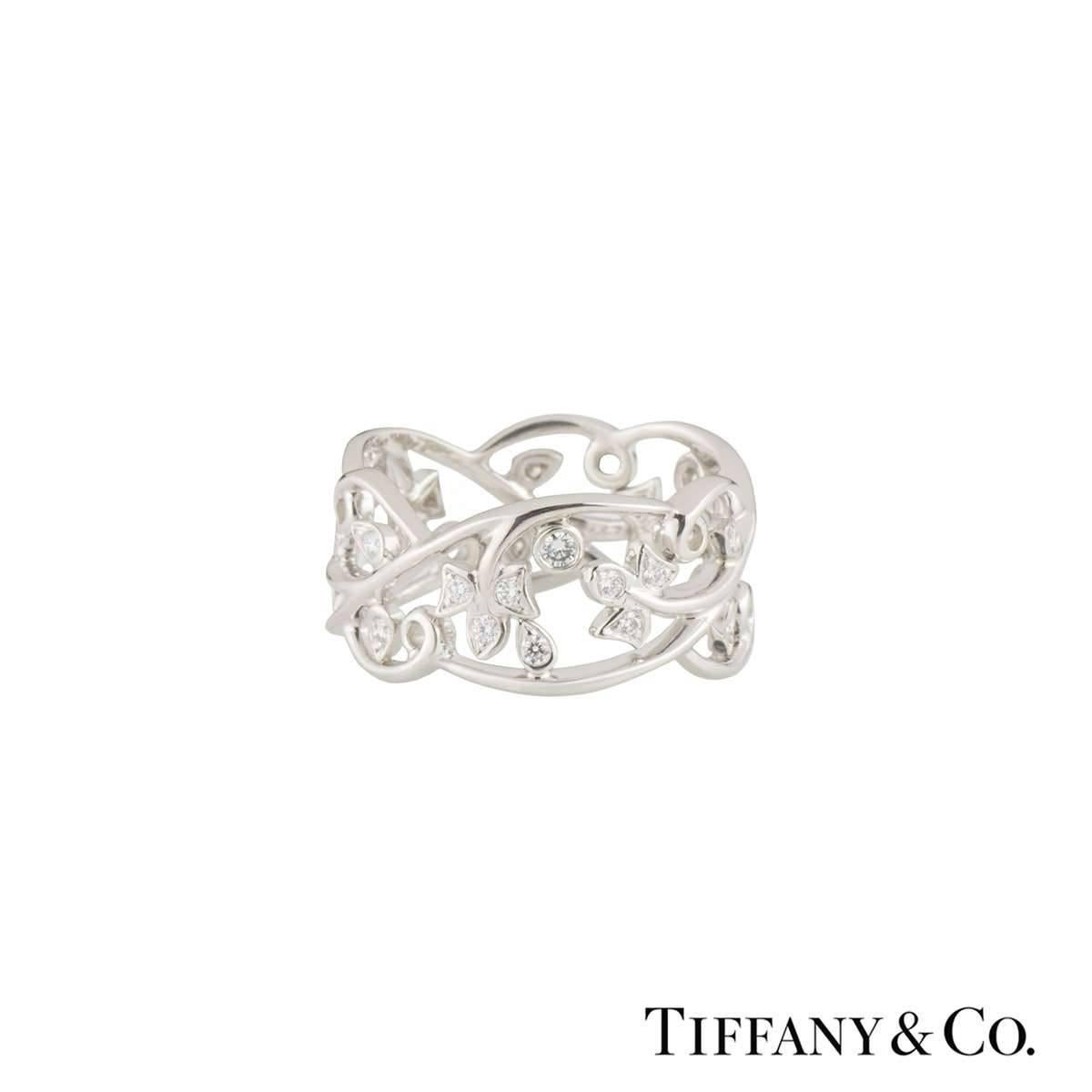 A lovely platinum Tiffany & Co. diamond dress ring. The ring comprises of an open work floral design with 30 round brilliant cut diamonds set around the band. The diamonds have a total weight of approximately 0.51ct, G colour and VS+ clarity.