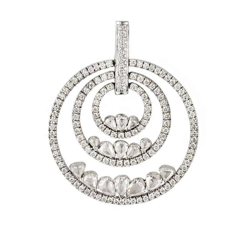 A beautiful 18k white gold diamond earring and pendant suite. The pendant comprises three circular open work motifs graduating in size and set within each other and each pave set with round brilliant cut diamonds. Accentuated each circular motif are
