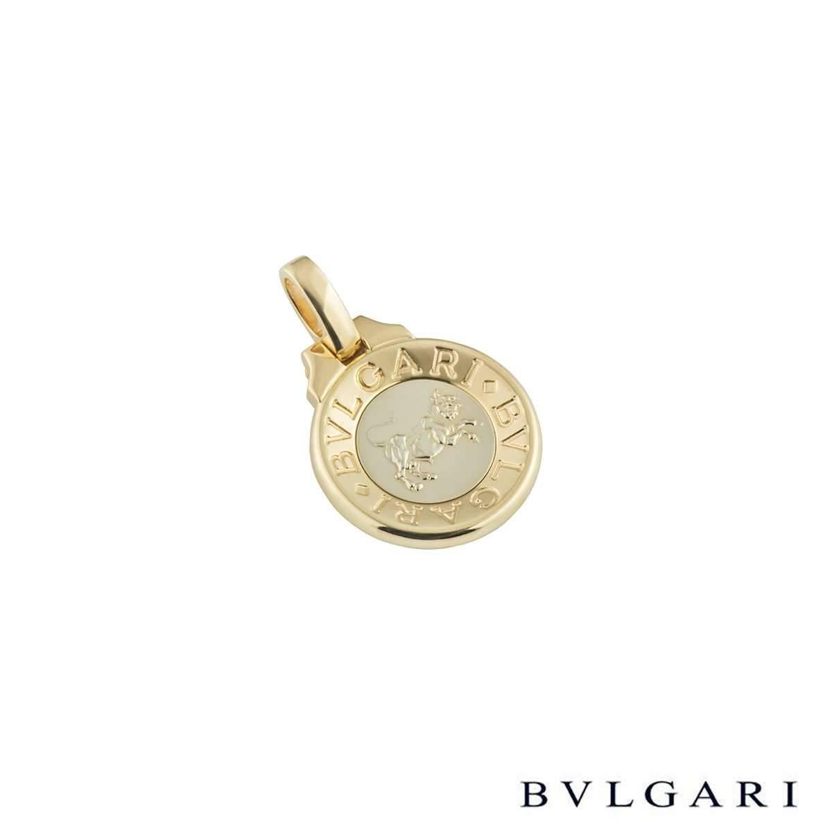 A unique 18k yellow and white gold Bvlgari zodiac pendant. The pendant comprises of a coin emblem with 'Bvlgari Bvlgari' around the outer edge. Complimenting this is a white gold centre with an embossed taurus zodiac sign. The pendant features a