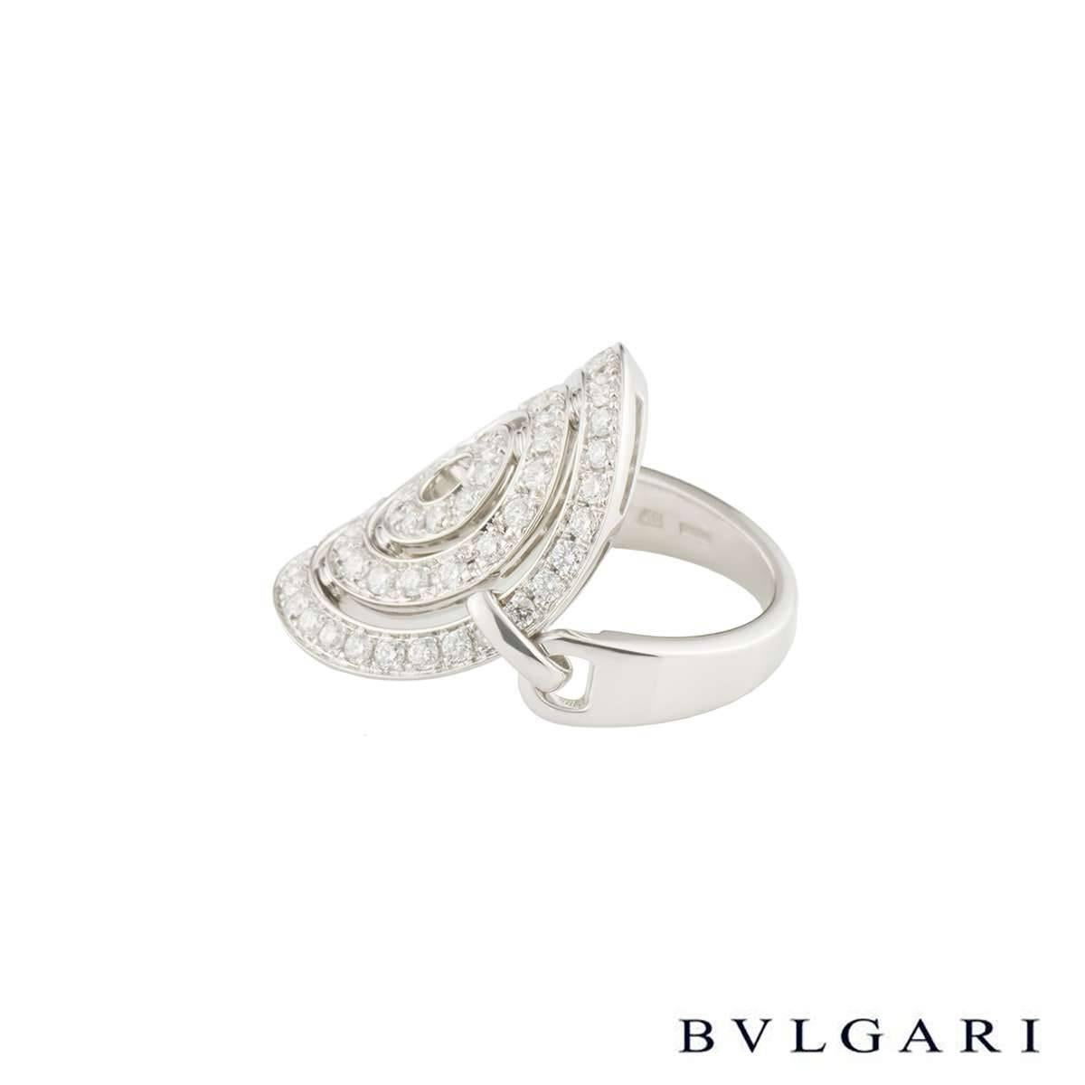 A stylish 18k white gold diamond Bvlgari ring from the Astrale collection. The 18k white gold ring features a swivel open design disc with the central disk with 62 round brilliant cut diamonds in a pave setting. The diamonds total approximately