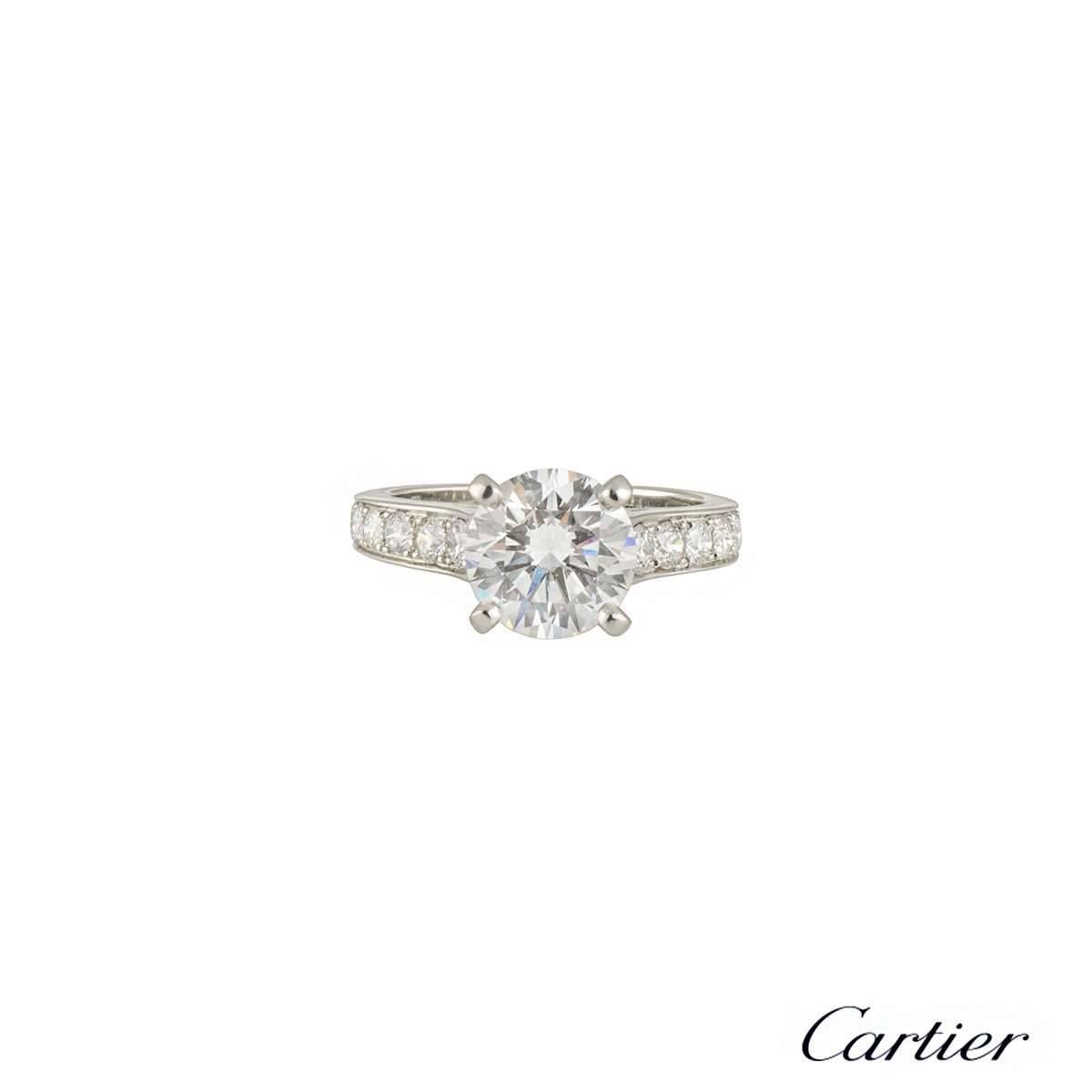 An exquisite Cartier diamond ring in platinum from the 1895 collection. The ring comprises of a round brilliant cut diamond in a claw setting with a total weight of 2.02ct, G colour and VS1 clarity. The ring features 9 round brilliant cut diamonds
