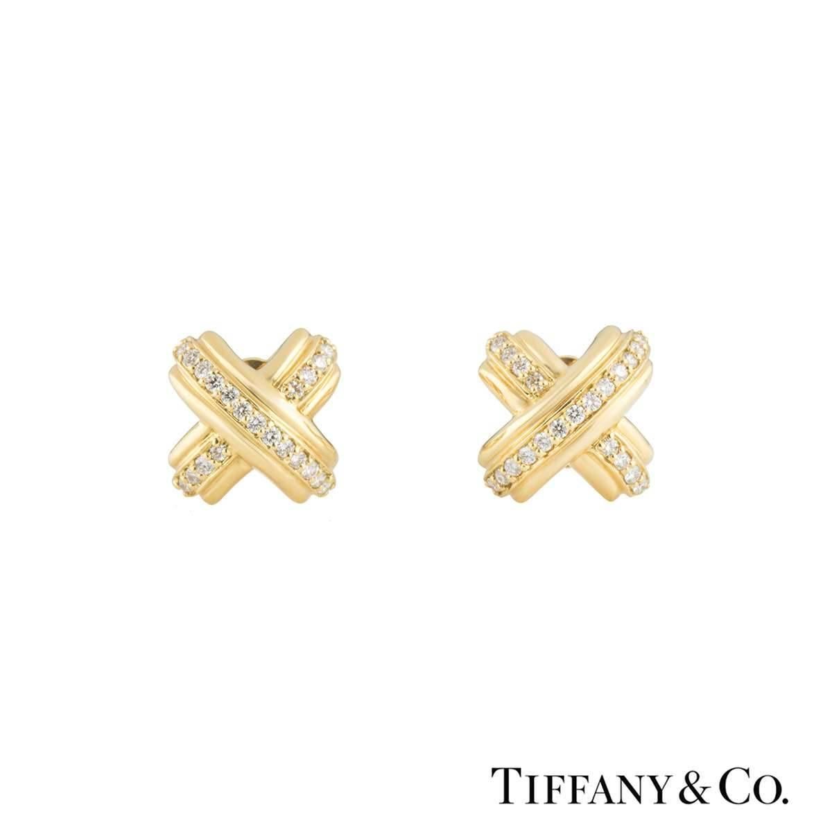 A pair of 18k yellow gold Tiffany & Co. diamond set cufflinks. The cufflinks are composed of the Signature 'X' cross motif, each set with 21 round brilliant cut diamonds, totalling approximately 0.55ct, G colour and VS clarity. The cufflinks