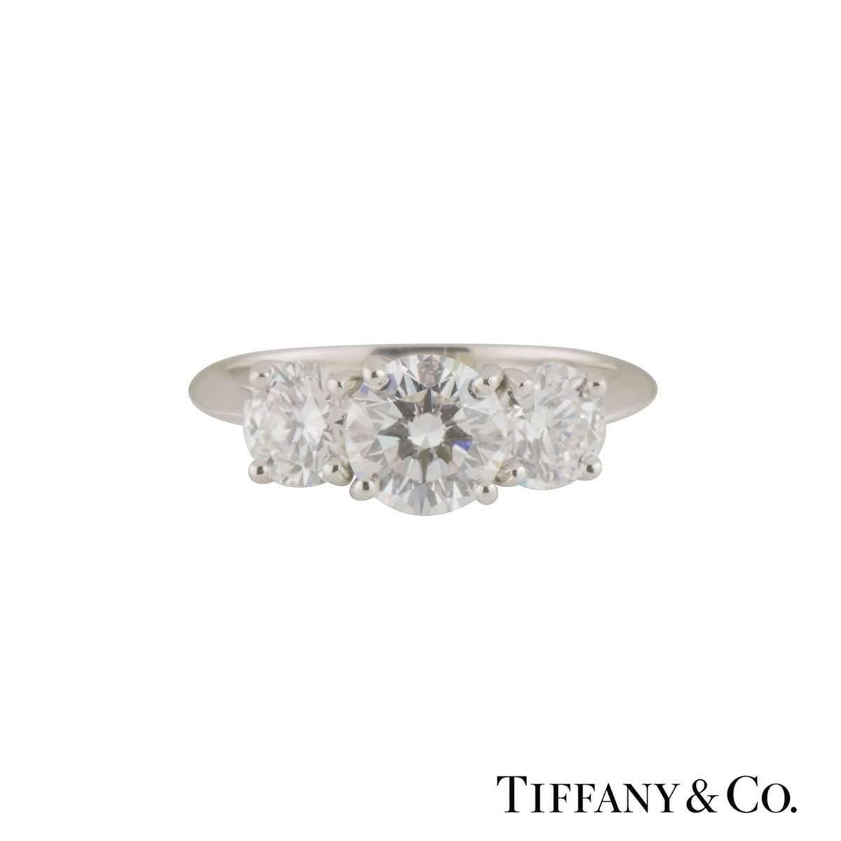 A stunning platinum Tiffany & Co. diamond trilogy ring. The ring comprises of a 1.26ct round brilliant cut diamond in a 4 claw setting, G colour, VS2 clarity. Complementing the central stone are 2 round brilliant cut diamonds set to each side.
