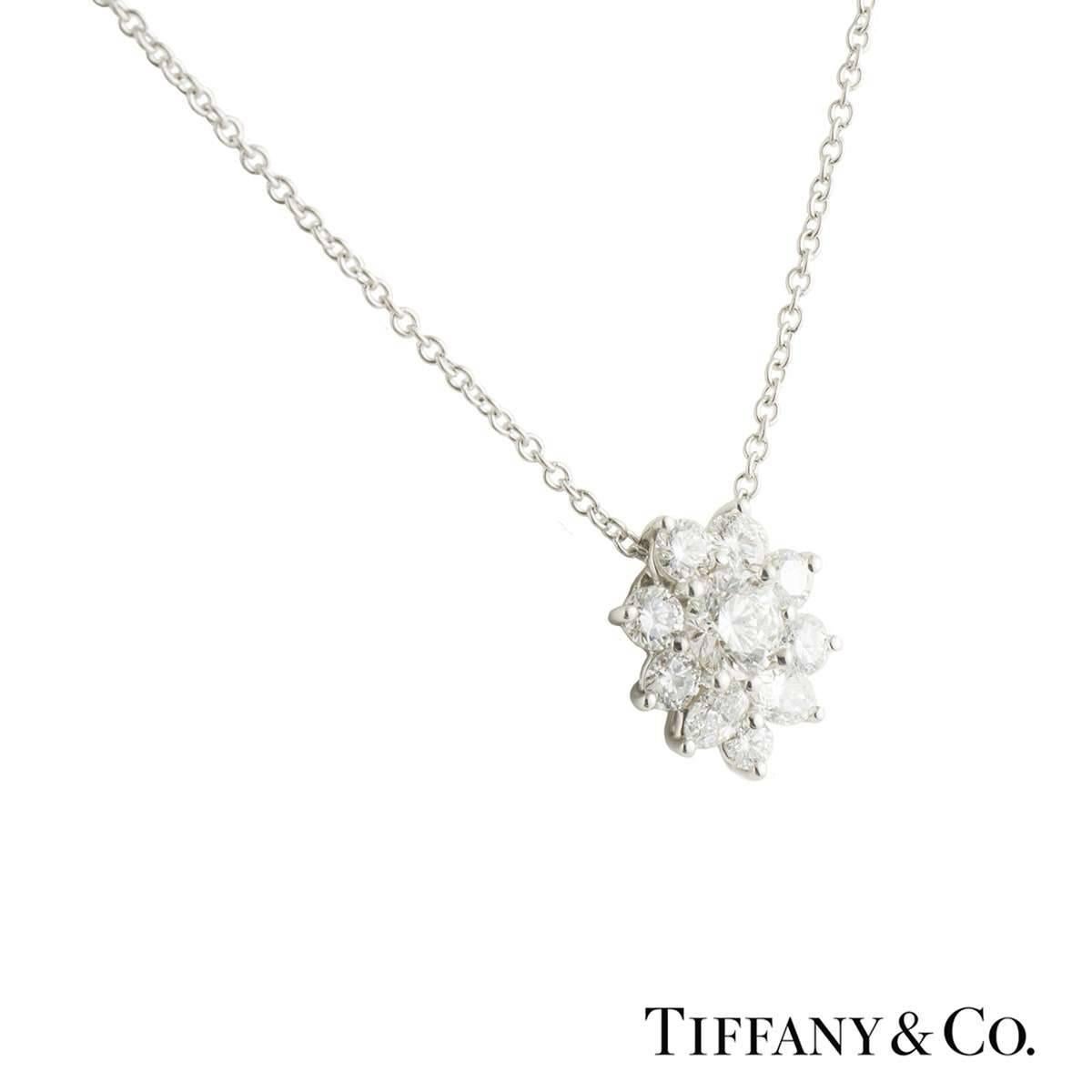 A beautiful Tiffany & Co. diamond pendant in platinum. The pendant comprises of a round brilliant cut diamond set to the centre with an approximate weight of 0.30ct, G colour and VVS2 clarity. Complimenting this are 2 pear cut diamonds with 7
