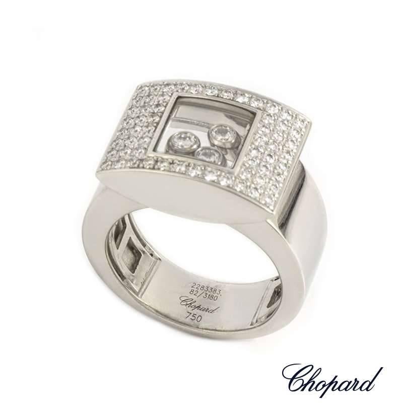 An 18k white gold ring from the Chopard Happy Curves collection. The ring is composed of a rectangular motif, pave set with round brilliant cut diamonds around the outer edge. Set to the centre of the motif are 3 floating round brilliant cut