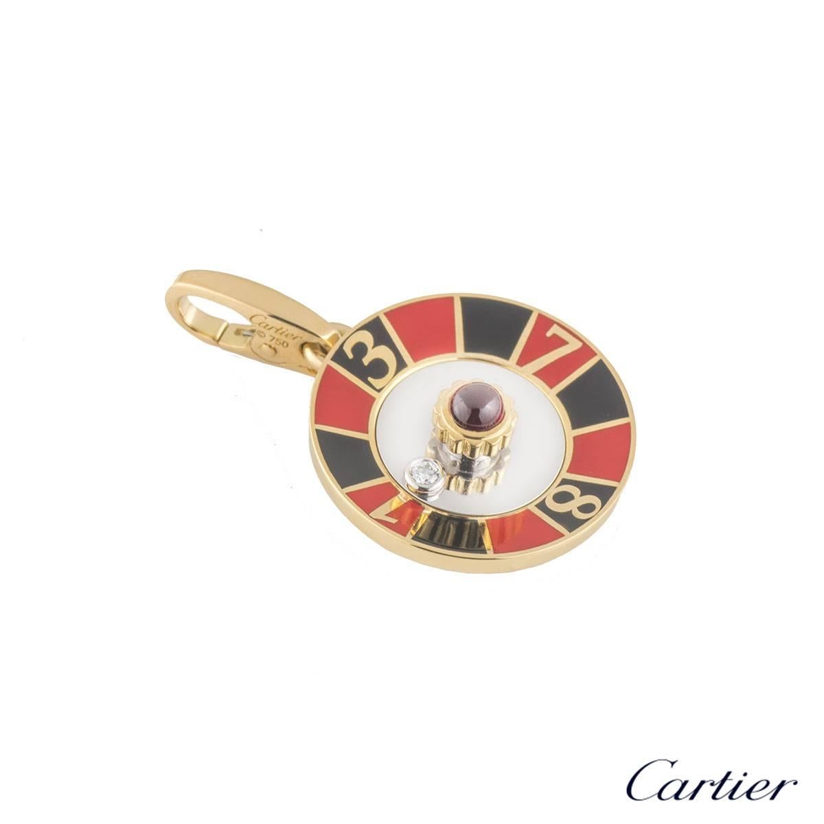 A unique 18k yellow gold Cartier charm. The charm comprises of a roulette motif with a cabachon ruby set to the centre. The charm is also complemented with a round brilliant cut diamond which freely moves in the centre. The charm features a lobster