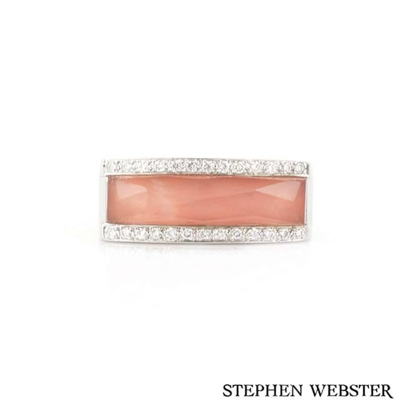 A Stephen Webster Crystal Haze coral and diamond ring in 18k white gold. The ring is of contemporary design, comprised of a layer of coral, faceted quartz and 26 round brilliant cut diamonds. The ring measures 9mm in width and tapers down to a 5mm