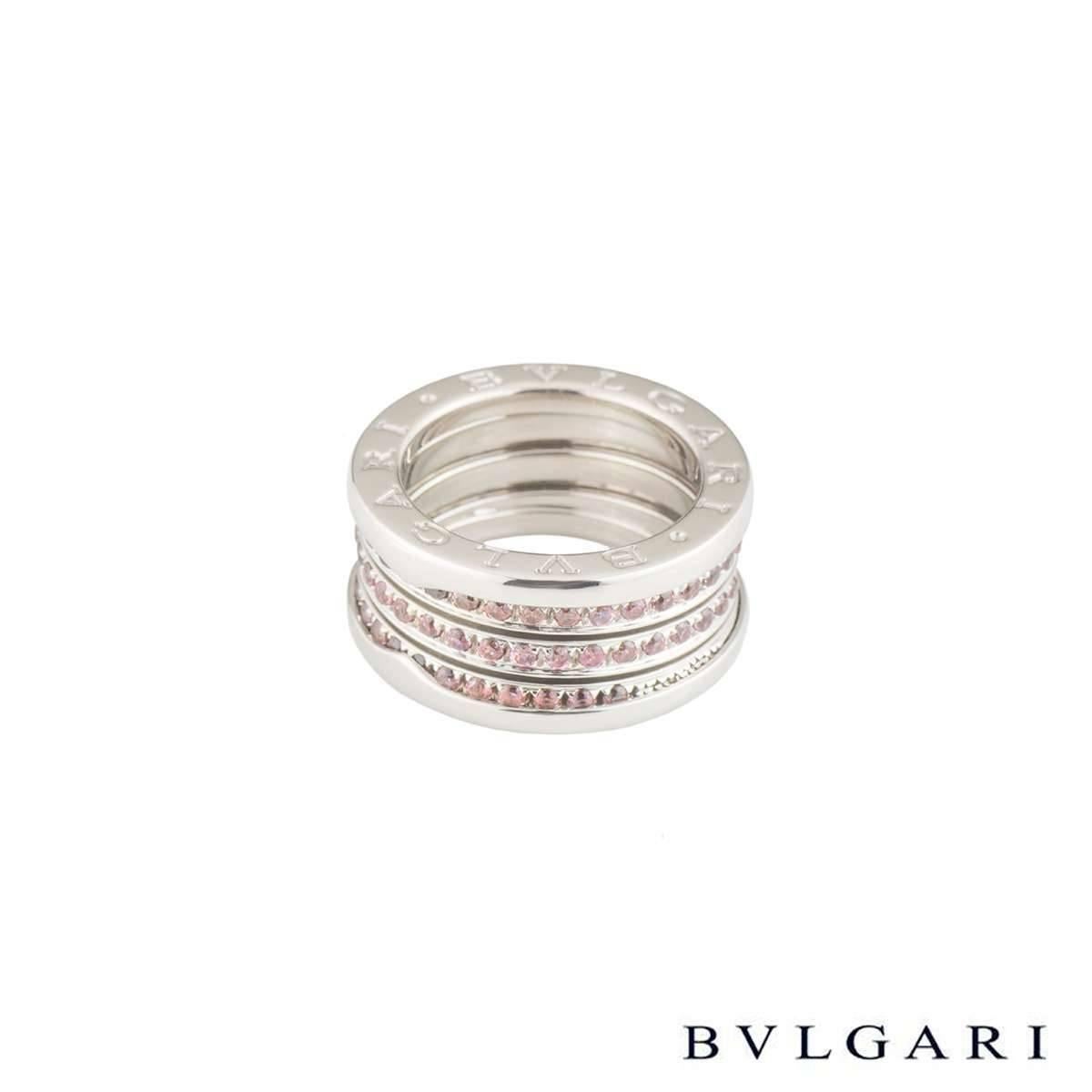 An 18k white gold pink sapphire B.zero1 ring by Bvlgari. The ring is composed of the signature spirals running through the centre, each pave set with round cut pink sapphires totalling approximately 1.24ct. The pink sapphires lead on to two