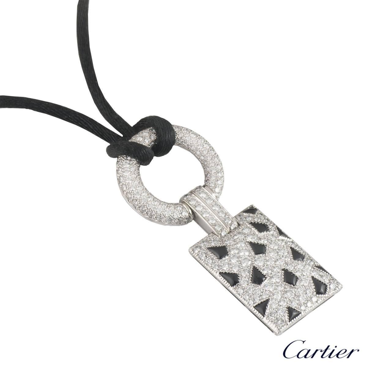 A stunning 18k white gold Cartier necklace from the Panthere de Cartier collection. The necklace comprises of a diamond set circular motif with a bar link connecting to a rectangular diamond and onyx set panels. The round brilliant cut diamonds