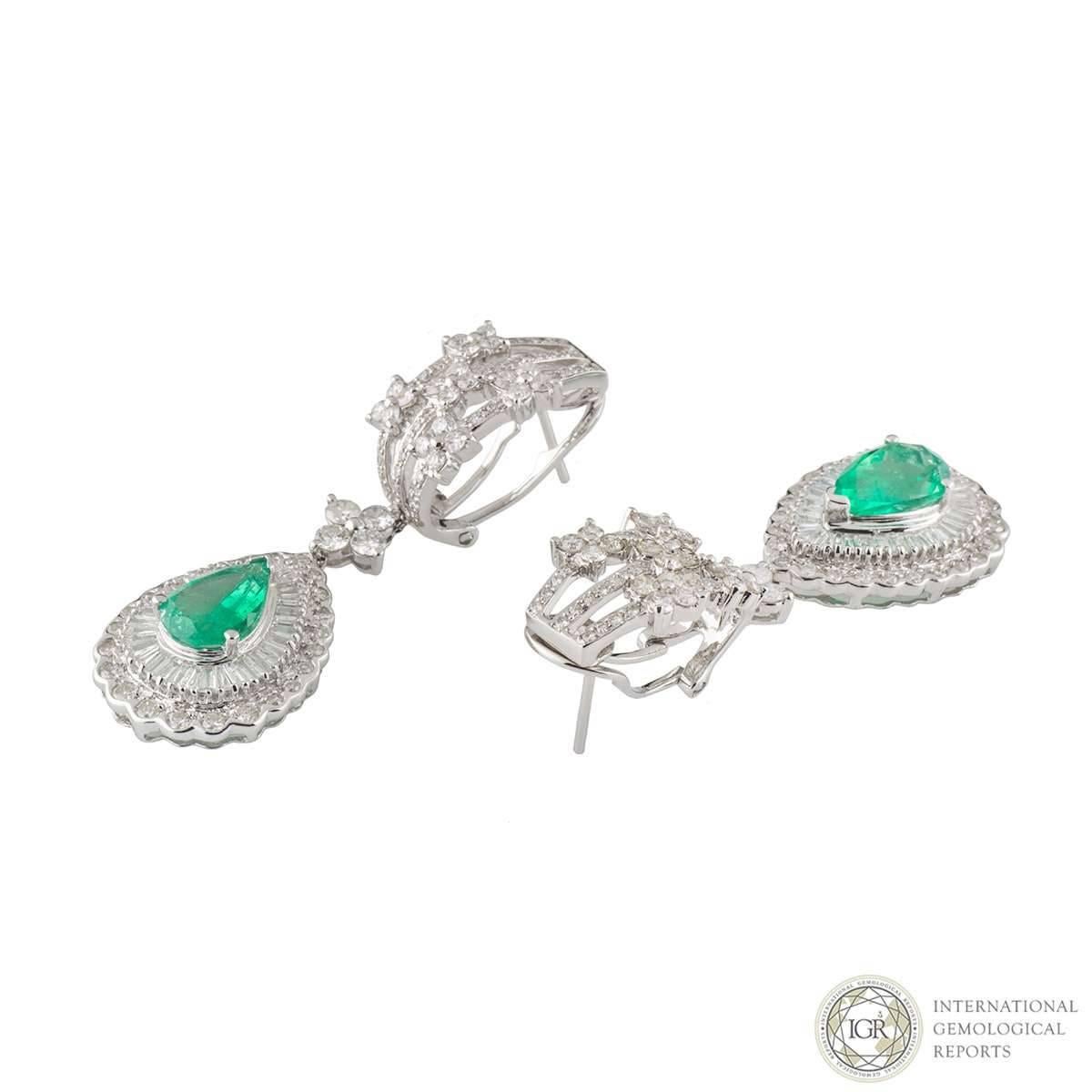 A lovely pair of 18k white gold diamond and emerald drop earrings. The earrings comprise of a 3 row openwork design with round brilliant cut diamonds. Accentuating this design is pear cut emerald in a claw setting with a double row of diamonds, both