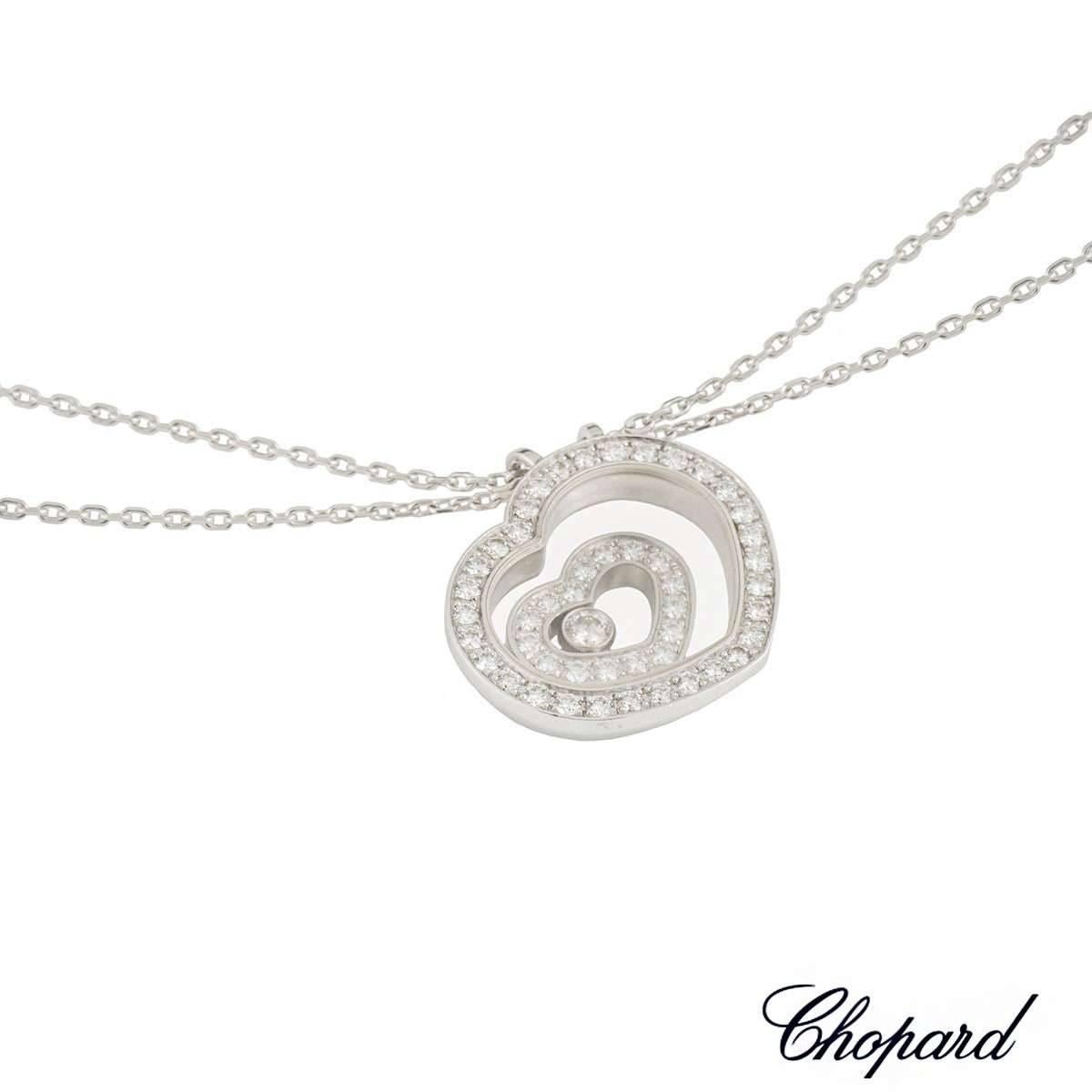 An 18k white gold pendant from the Chopard Happy Spirit collection. The pendant is composed of a heart shape pendant, set to the centre with a freely moving smaller heart, each pave set with round brilliant cut diamonds, totalling 0.47ct, colour G