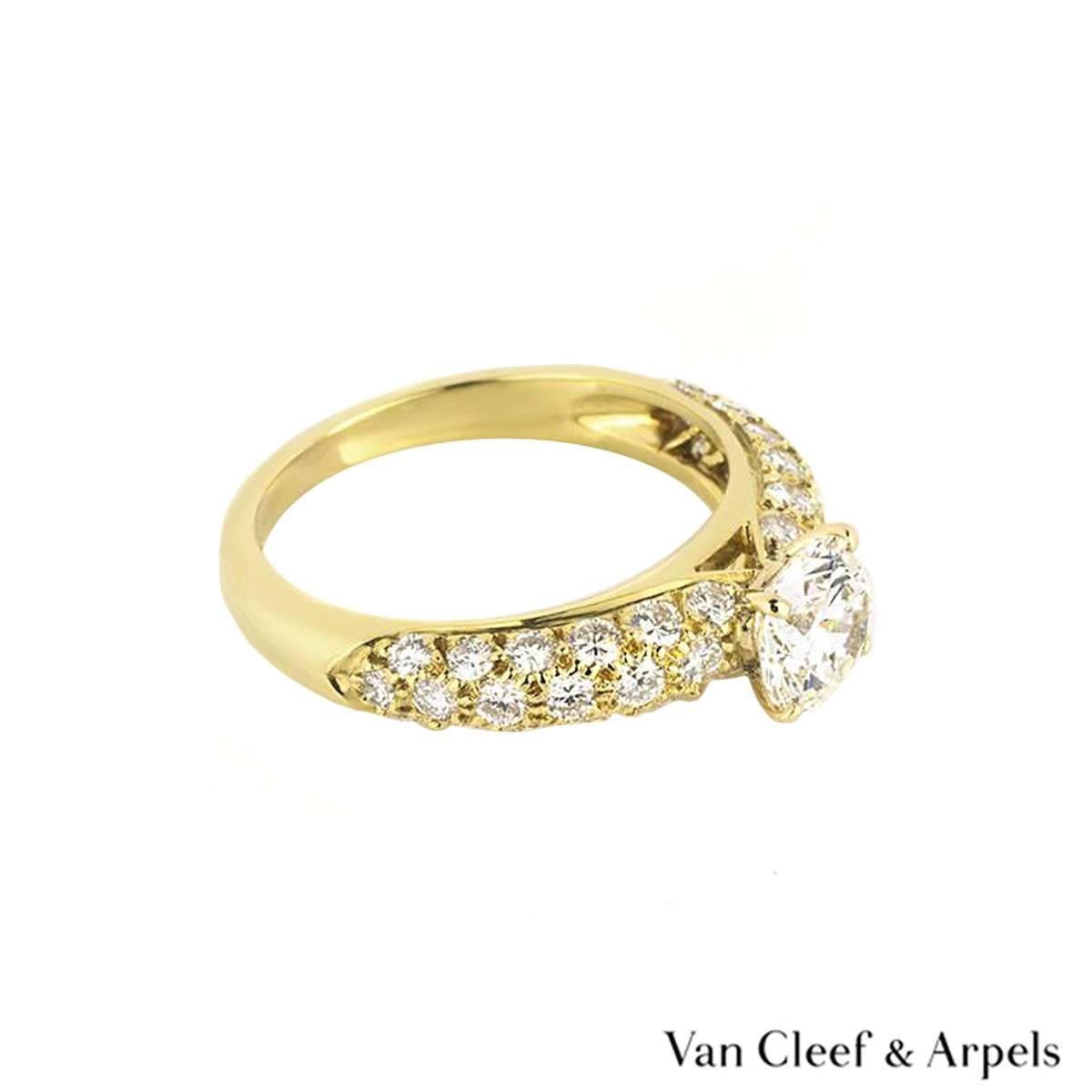 A sparkly 18k yellow gold Van Cleef & Arpels diamond ring. The ring comprises of a round brilliant cut diamond weighing approximately 0.71ct, F colour and VS1 clarity. The centre stone is accentuated by pave set with 36 round brilliant cut diamond