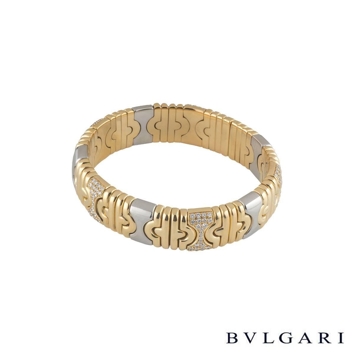 A unique stainless steel and 18k yellow gold diamond Bvlgari bangle from the Parentesi collection. The bangle comprises of alternating plain and diamond set geometrical design intersections like the iconic parentesi design. There are 120 diamonds