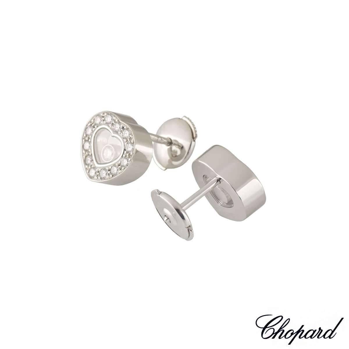 A pair of 18k white gold diamond earrings from the Chopard Happy Diamonds collection. The heart shape earrings have 24 pave set round brilliant cut diamond around the outer edges totalling 0.41ct. Complete with 2 single signature floating round