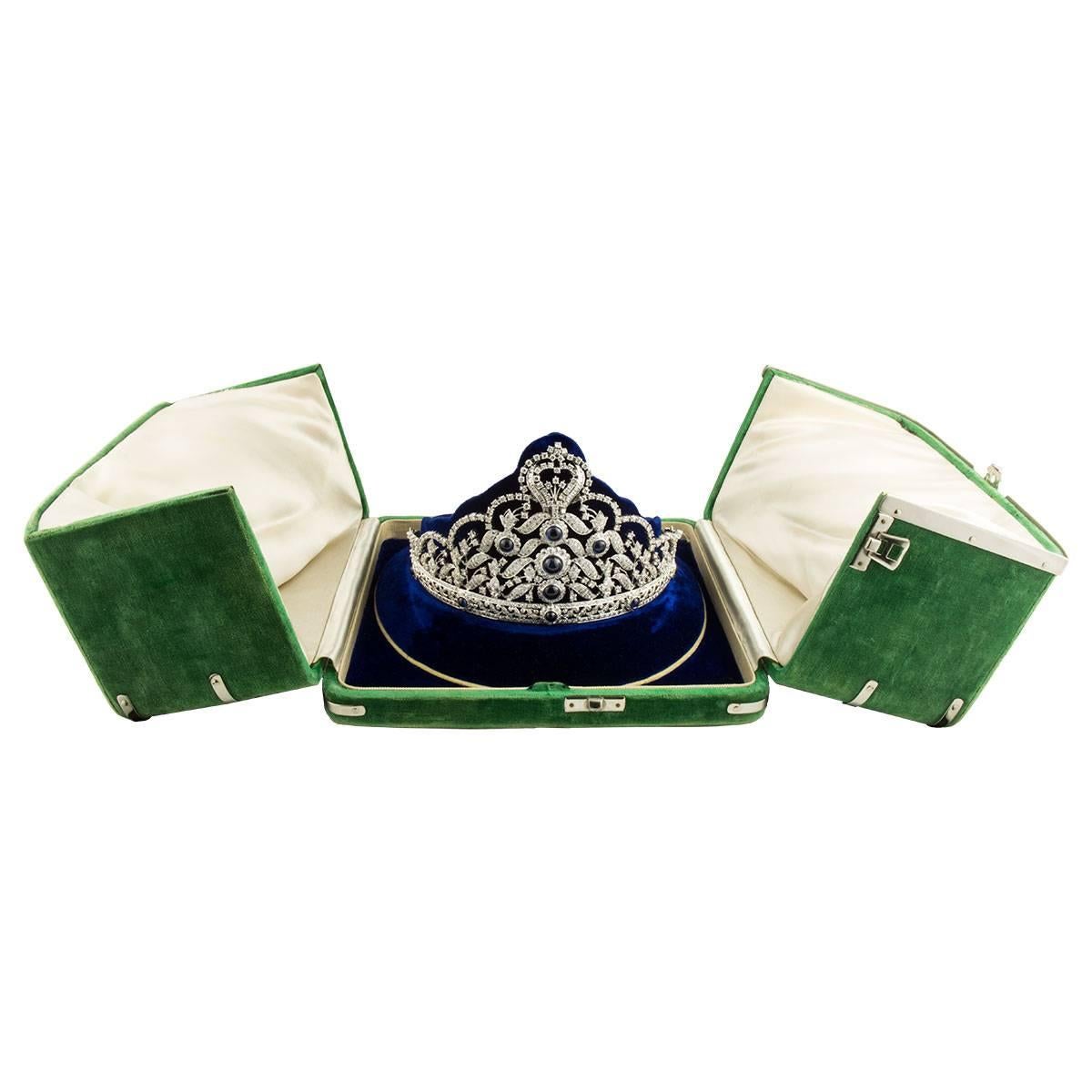 An exclusive 18k white gold diamond and sapphire tiara. The tiara is set to the front with 10 cabochon cut blue sapphires varying in size, from 0.65ct to 3.50ct. The sapphires have a total approximate weight of 12.15ct and display a rich even blue