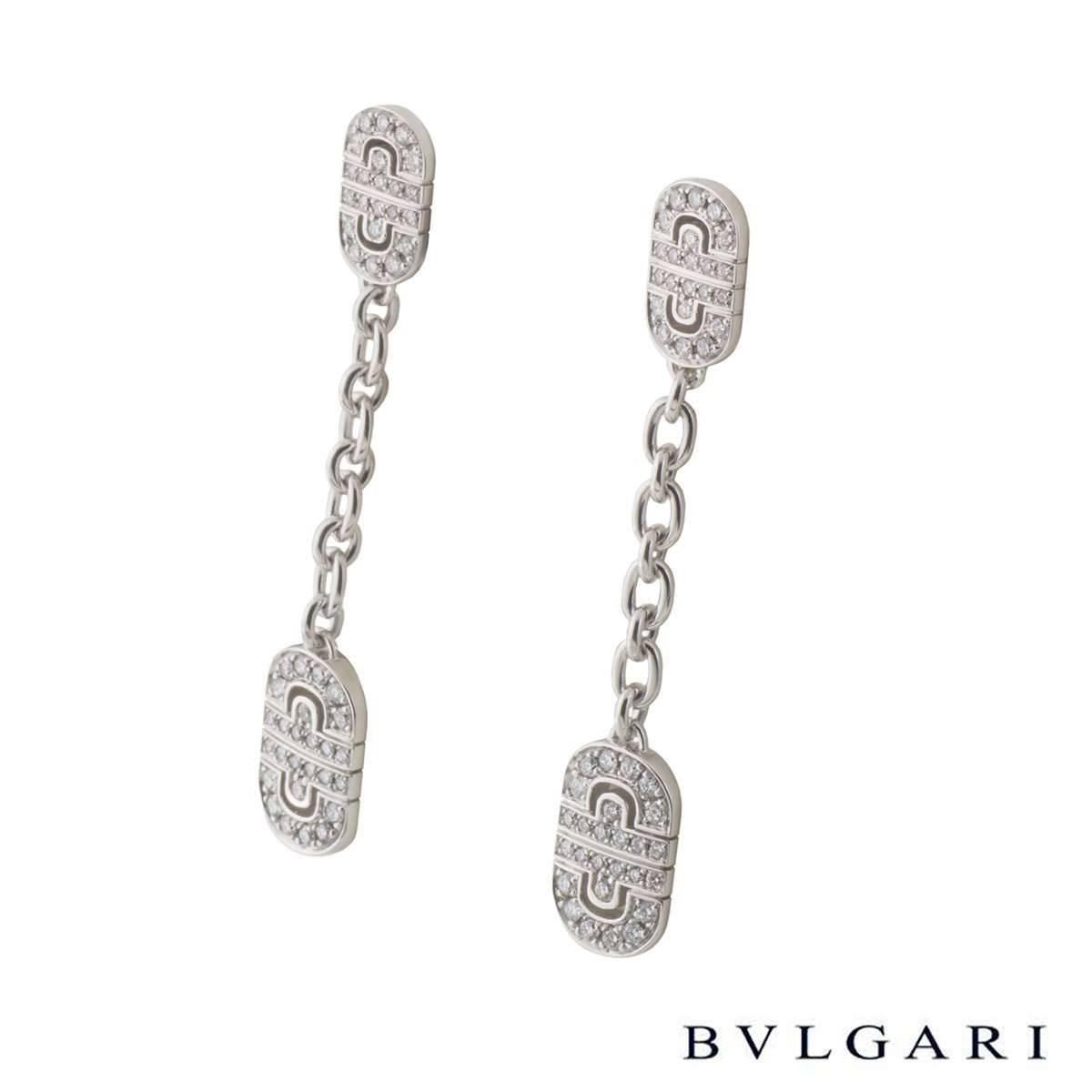 A pair of 18k white gold earrings from the Parentesi collection by Bulgari. The drop earrings are composed of two diamond set panels featuring a geometric design suspended from each other. The earrings are set with pave round brilliant cut diamonds