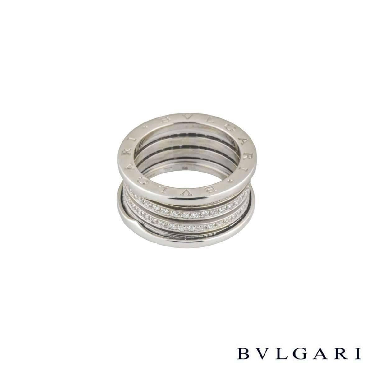 An 18k white gold diamond set B.zero1 ring by Bulgari. The ring is composed of signature spirals set with round brilliant cut white pave set diamonds leading to the outer engraved 'Bvlgari Bvlgari' signed terminations. The ring is a US size 6 1/2