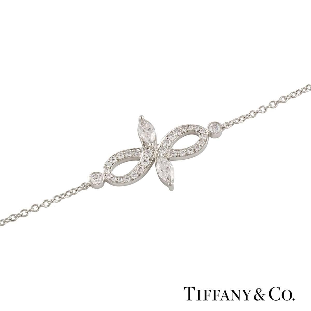 A beautiful 18k white gold Tiffany & Co. diamond bracelet from the Victoria collection. The bracelet comprises of an open work design with 2 marquise cut diamonds at each end with a total weight of 0.13ct, F colour and VS+ clarity. Complementing the